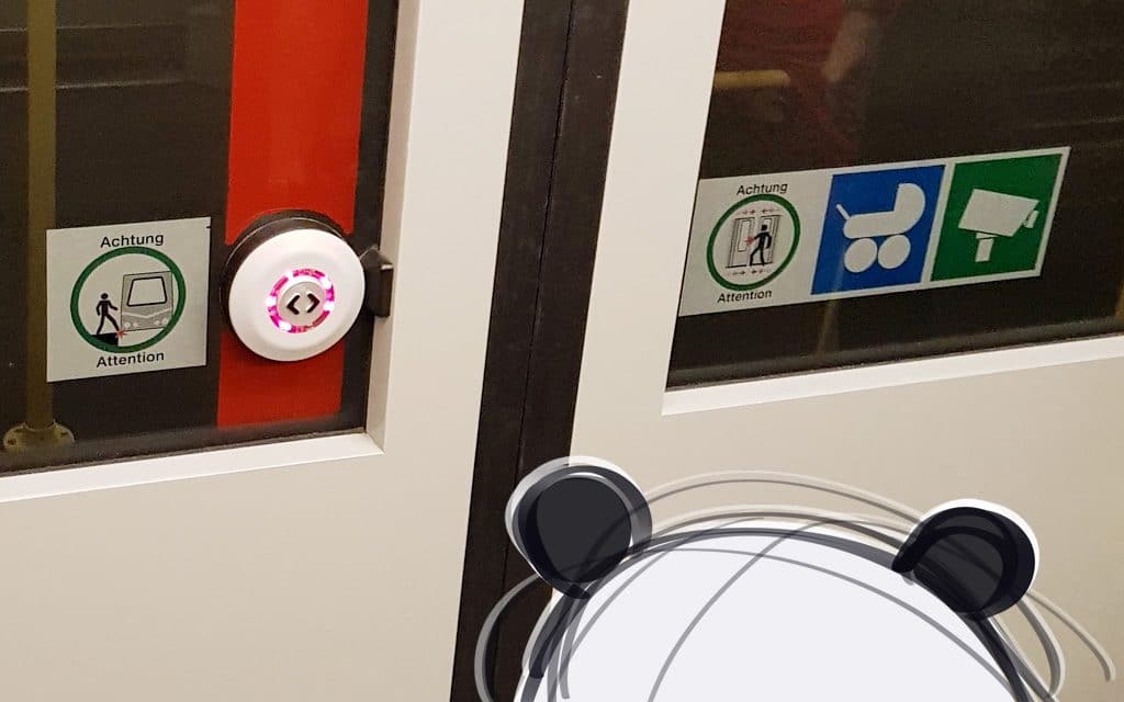 Mister Wong staring at the door button in a new subway train in Vienna.