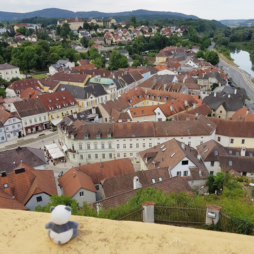 Plushie panda Mister Wong looking down from Melk Abbey.